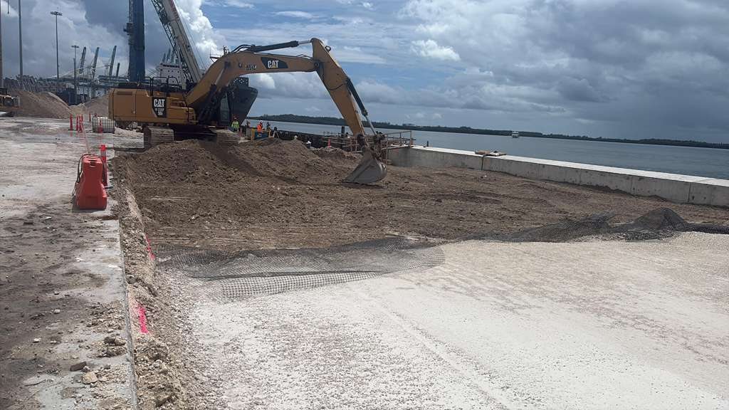 A PEC CAT excavator grading and excavating a waterfront site